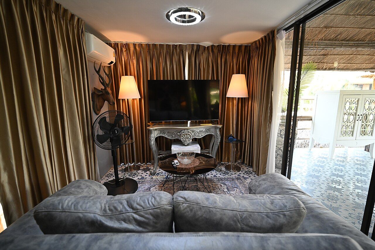 Living room lit by warm floor lamps